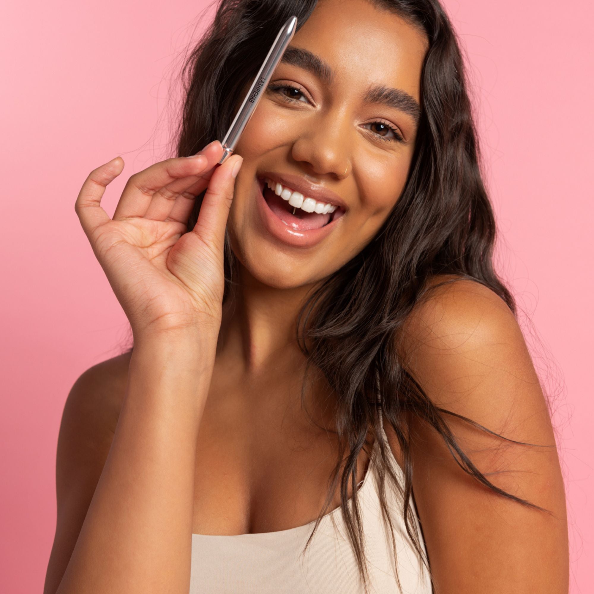 Woman holding reusable lash wand from Lash Rehab