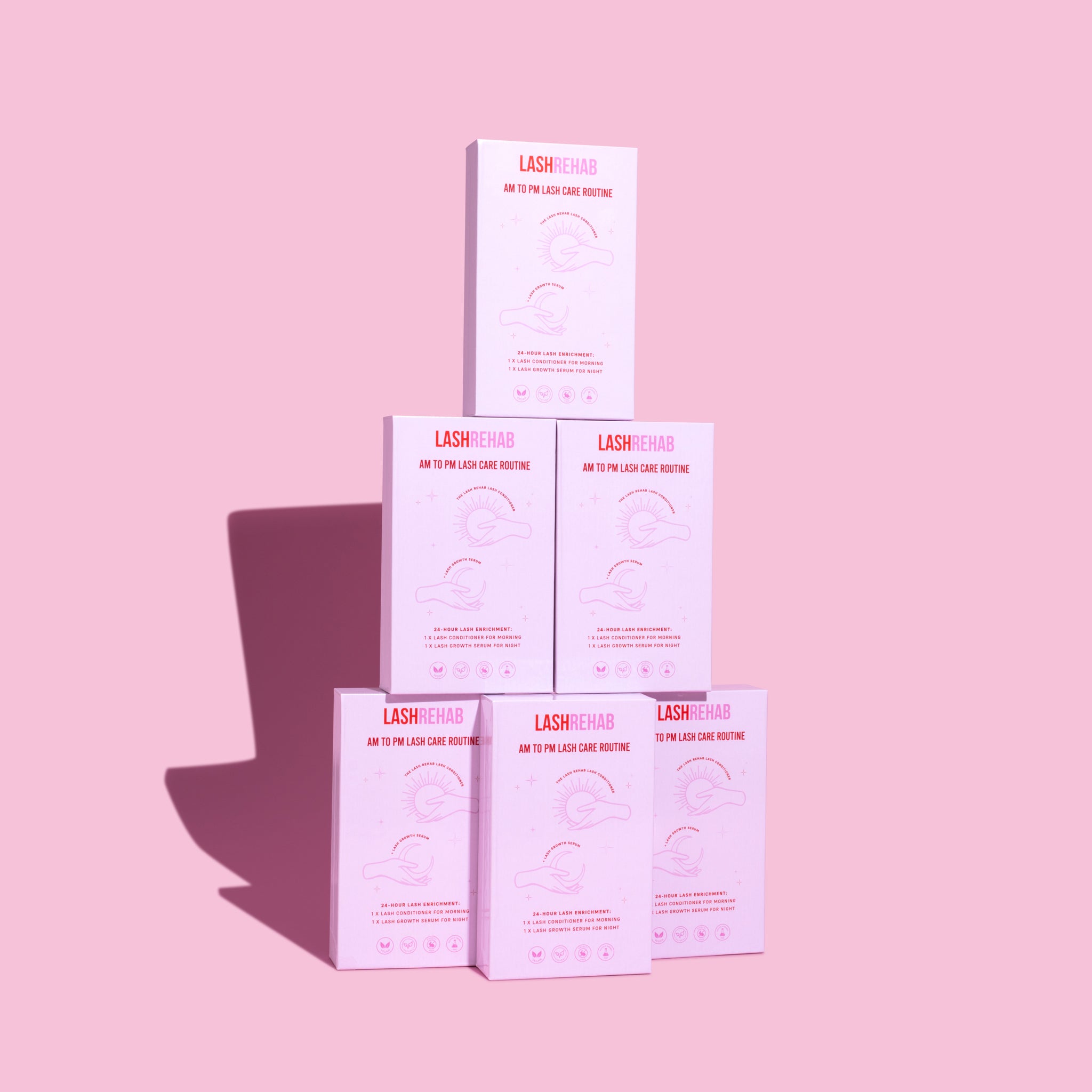 Stack of 6 AM to PM Lash Rehab Lash Serum Kits – wholesale lash growth serum bundle for beauty salons and lash businesses, pink packaging.